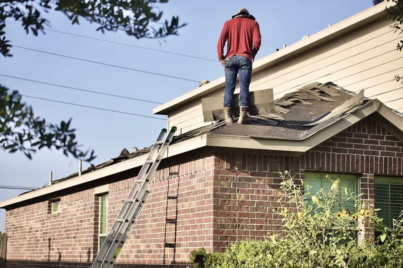 Professional roofer working on a residential roof in Old Farm